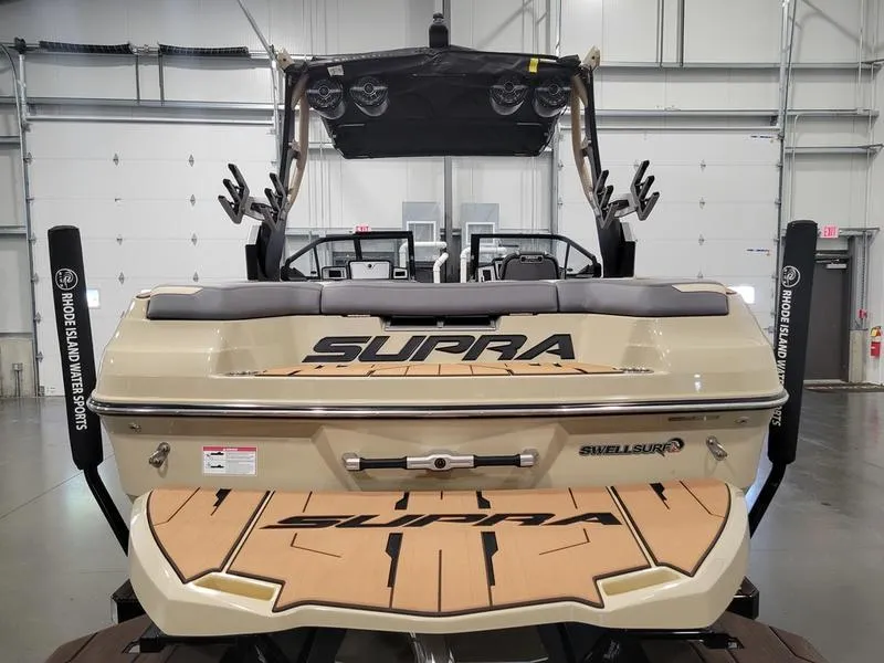 Slide: The Image of 2022 Supra SR400 boat in a showroom, rear view with Supra branding. - 5