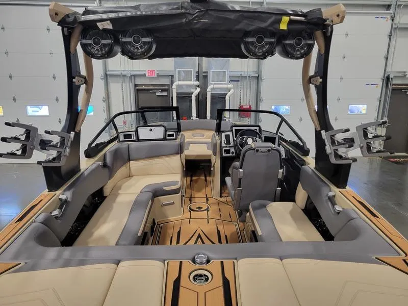 Slide: The Image of 2022 Supra SR400 boat interior with beige and gray seating, advanced dashboard, and sound system. - 8