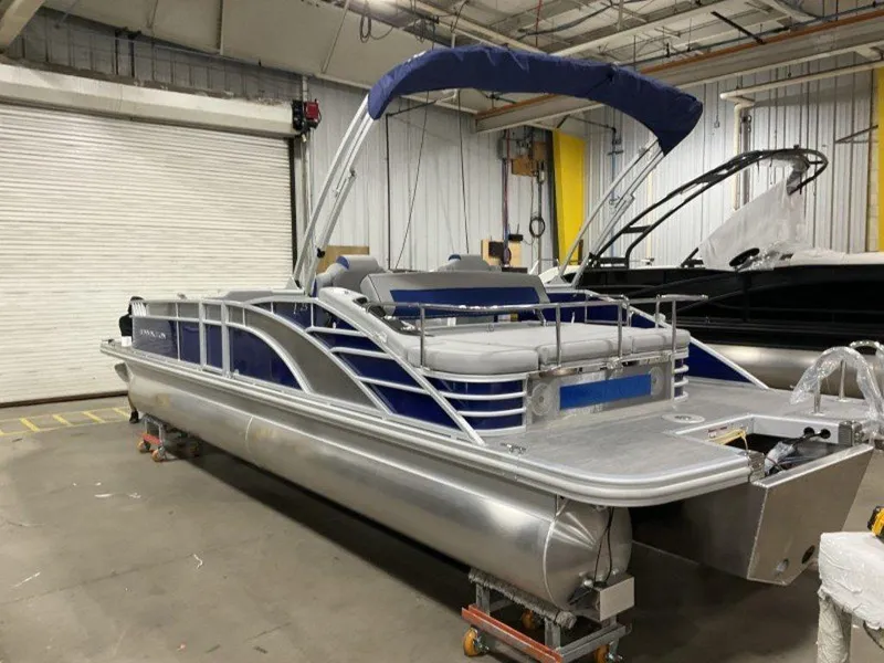 Slide: The Image of 2023 Bennington 25 LTSB pontoon boat in a warehouse. - 10