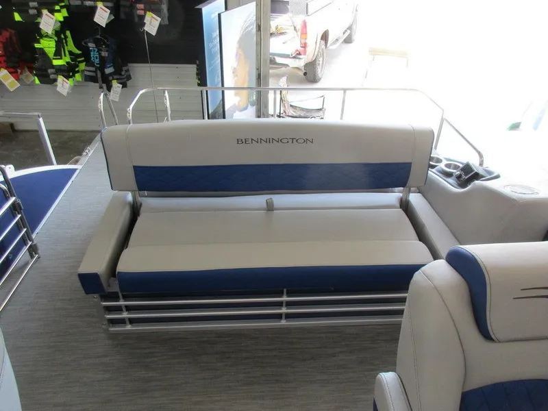 Slide: The Image of 2023 Bennington 25 LTSB boat interior with blue and white seating. - 12