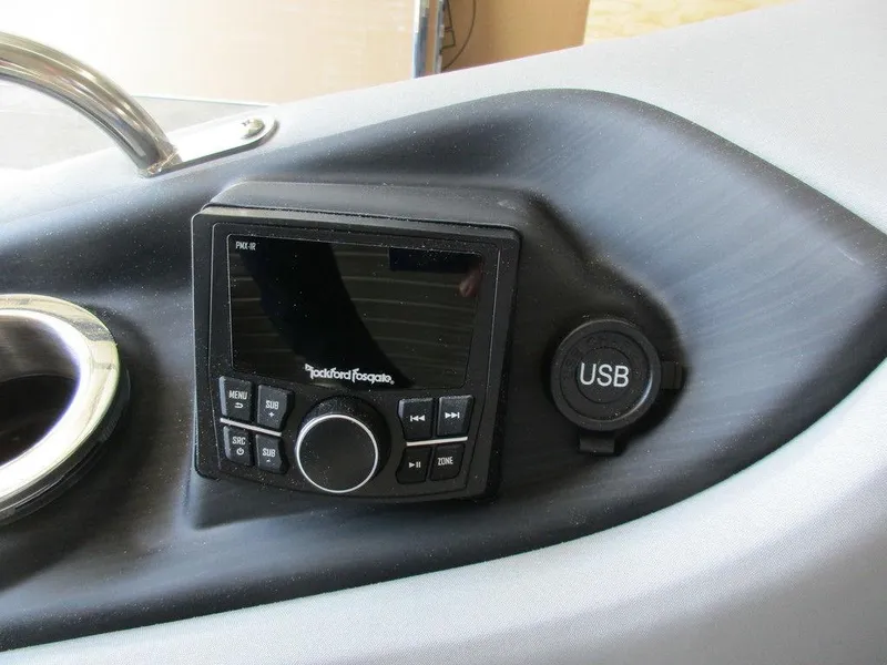 Slide: The Image of Bennington 25 LTSB 2023 boat dashboard with Rockford Fosgate stereo and USB port. - 16