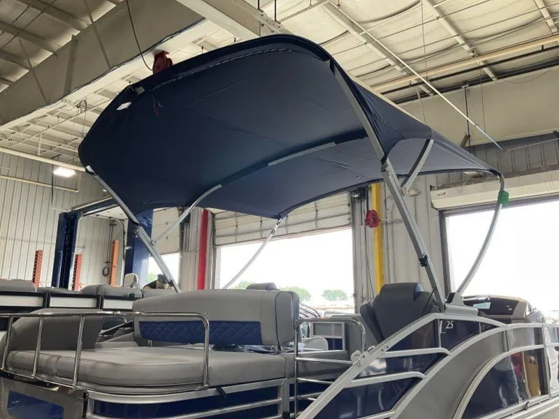 Slide: The Image of 2023 Bennington 25 LTSB pontoon boat with canopy in a showroom. - 18
