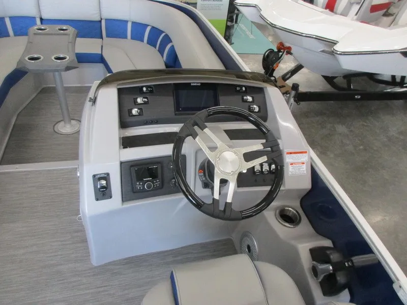 Slide: The Image of 2023 Bennington 25 LTSB boat interior with steering wheel and control panel. - 5