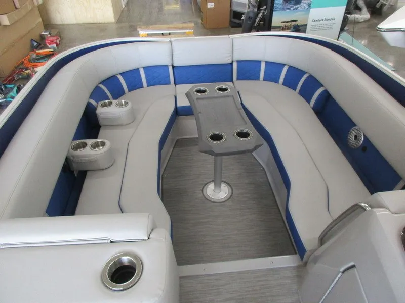 Slide: The Image of 2023 Bennington 25 LTSB boat interior with U-shaped seating and cup holders. - 7