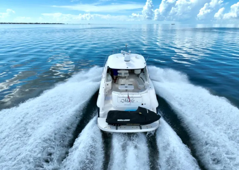 Slide: The Image of 2004 Sea Ray 500 Sundancer cruising on calm waters. - 11