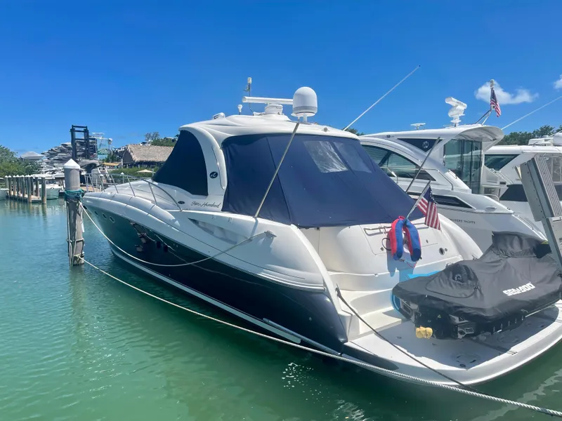 Slide: The Image of 2004 Sea Ray 500 Sundancer yacht docked in marina, clear blue sky. - 13