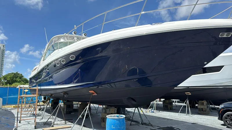 Slide: The Image of 2004 Sea Ray 500 Sundancer yacht on dry dock under clear blue sky. - 15
