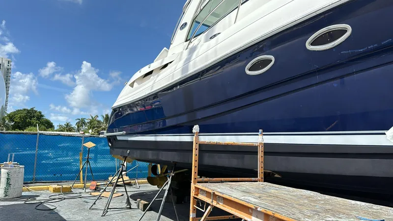Slide: The Image of 2004 Sea Ray 500 Sundancer yacht under maintenance in a sunny marina. - 17