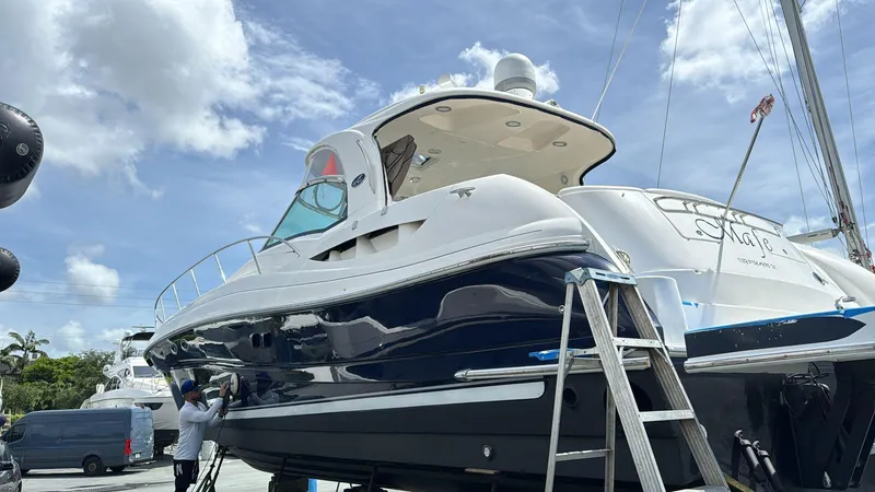 Slide: The Image of 2004 Sea Ray 500 Sundancer yacht on dry dock under a partly cloudy sky. - 19