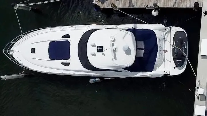 Slide: The Image of Overhead view of a 2004 Sea Ray 500 Sundancer yacht docked at a marina. - 2