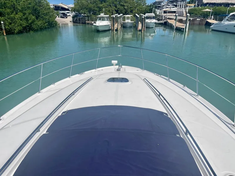 Slide: The Image of 2004 Sea Ray 500 Sundancer yacht docked in a serene marina. - 23
