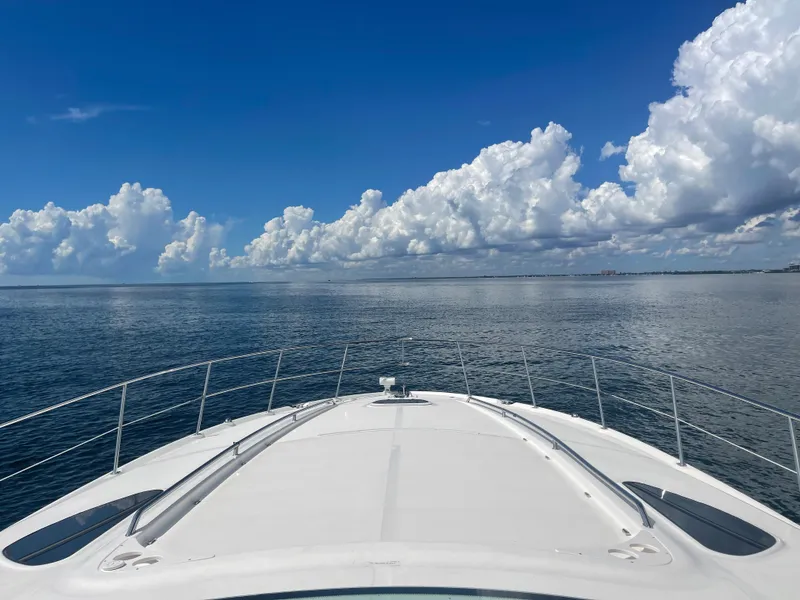 Slide: The Image of Bow view of 2004 Sea Ray 500 Sundancer yacht on calm ocean waters. - 26