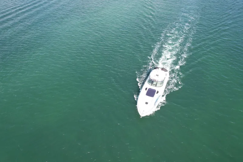 Slide: The Image of Aerial view of 2004 Sea Ray 500 Sundancer cruising on clear water. - 29