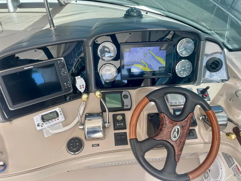 Slide: The Image of 2004 Sea Ray 500 Sundancer helm with navigation screens and controls. - 36