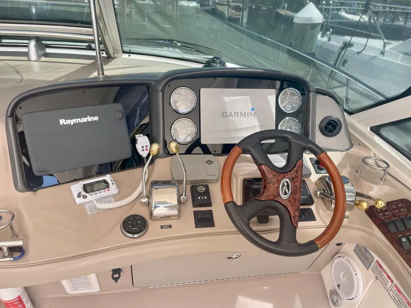 Slide: The Image of 2004 Sea Ray 500 Sundancer helm with Raymarine and Garmin navigation systems. - 37