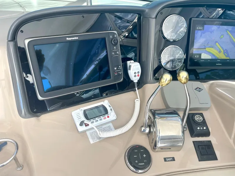 Slide: The Image of Control panel of 2004 Sea Ray 500 Sundancer with navigation screens and gauges. - 38