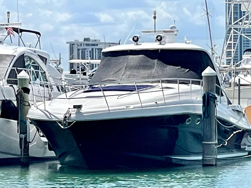 Slide: The Image of 2004 Sea Ray 500 Sundancer yacht docked in marina, surrounded by other boats. - 4