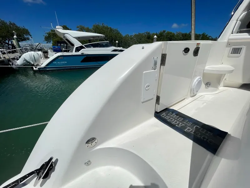 Slide: The Image of 2004 Sea Ray 500 Sundancer yacht docked in a marina under clear blue skies. - 44