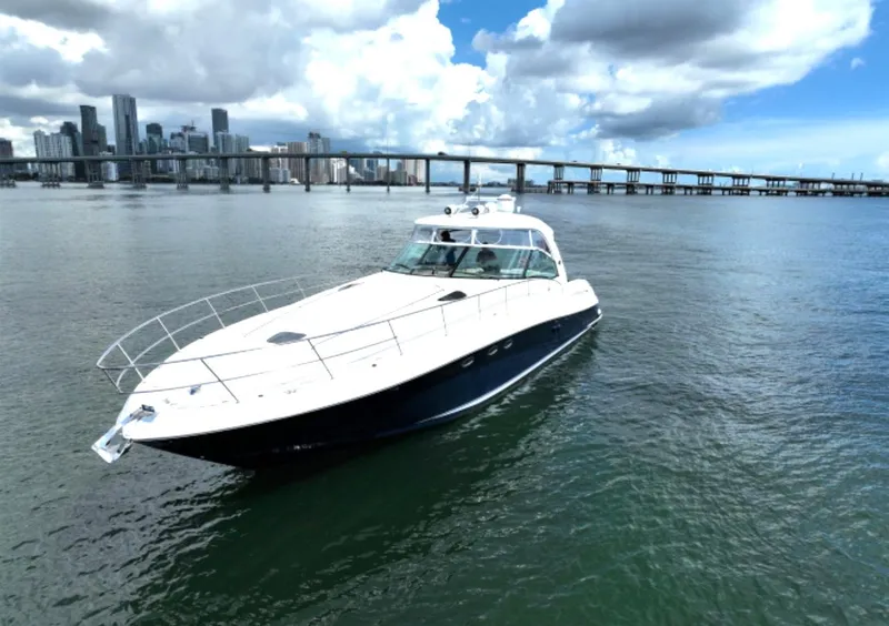 Slide: The Image of 2004 Sea Ray 500 Sundancer yacht cruising near city skyline and bridge. - 5