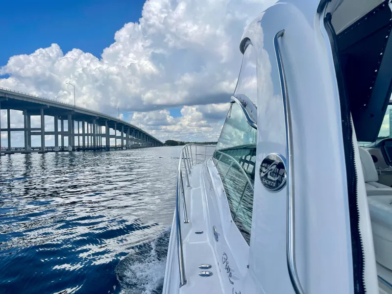 Slide: The Image of 2004 Sea Ray 500 Sundancer cruising near a bridge on a sunny day. - 55