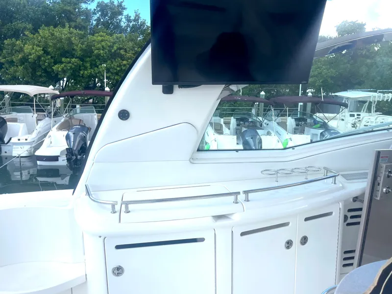 Slide: The Image of 2004 Sea Ray 500 Sundancer yacht with outdoor entertainment area and TV. - 57