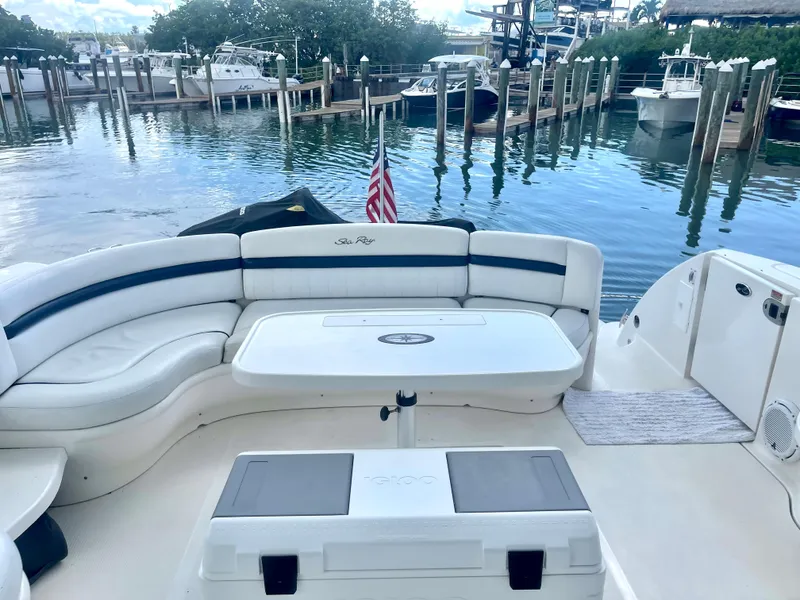 Slide: The Image of 2004 Sea Ray 500 Sundancer yacht with spacious seating at a marina. - 59