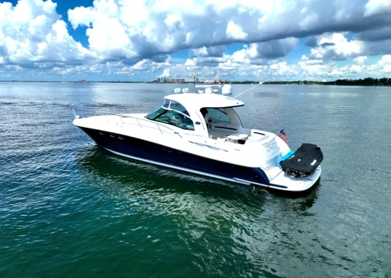 Slide: The Image of 2004 Sea Ray 500 Sundancer yacht cruising on calm waters under a partly cloudy sky. - 6