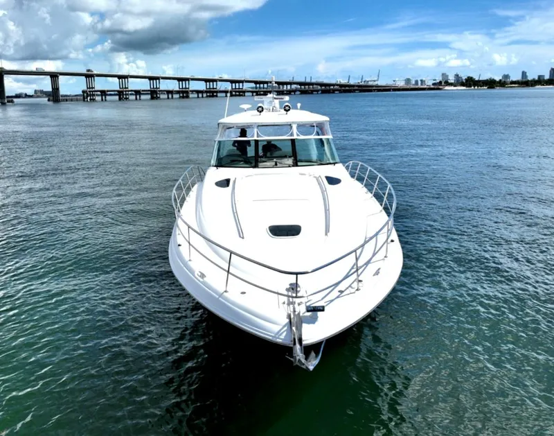 Slide: The Image of 2004 Sea Ray 500 Sundancer yacht on calm waters with a bridge in the background. - 8