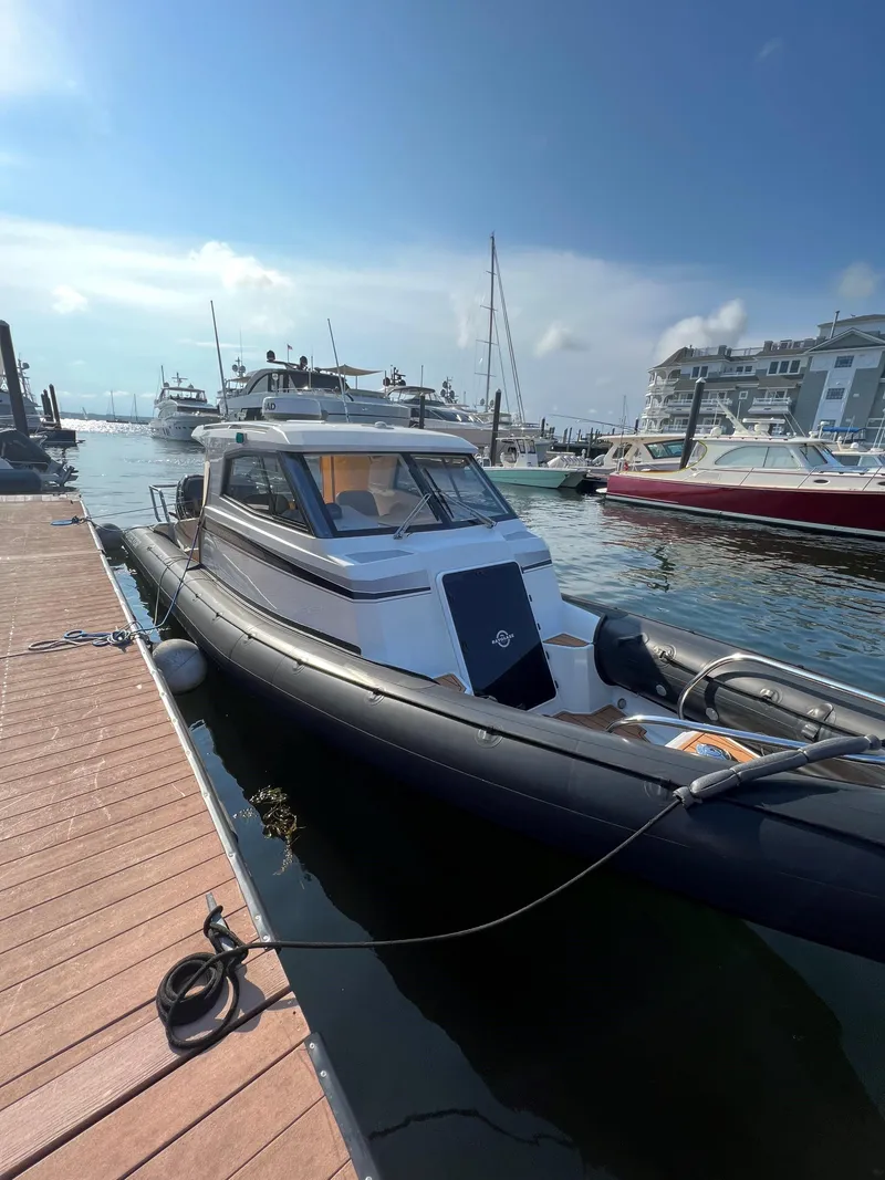 Slide: The Image of 2020 Protector 330 Targa boat docked at marina under clear sky. - 10