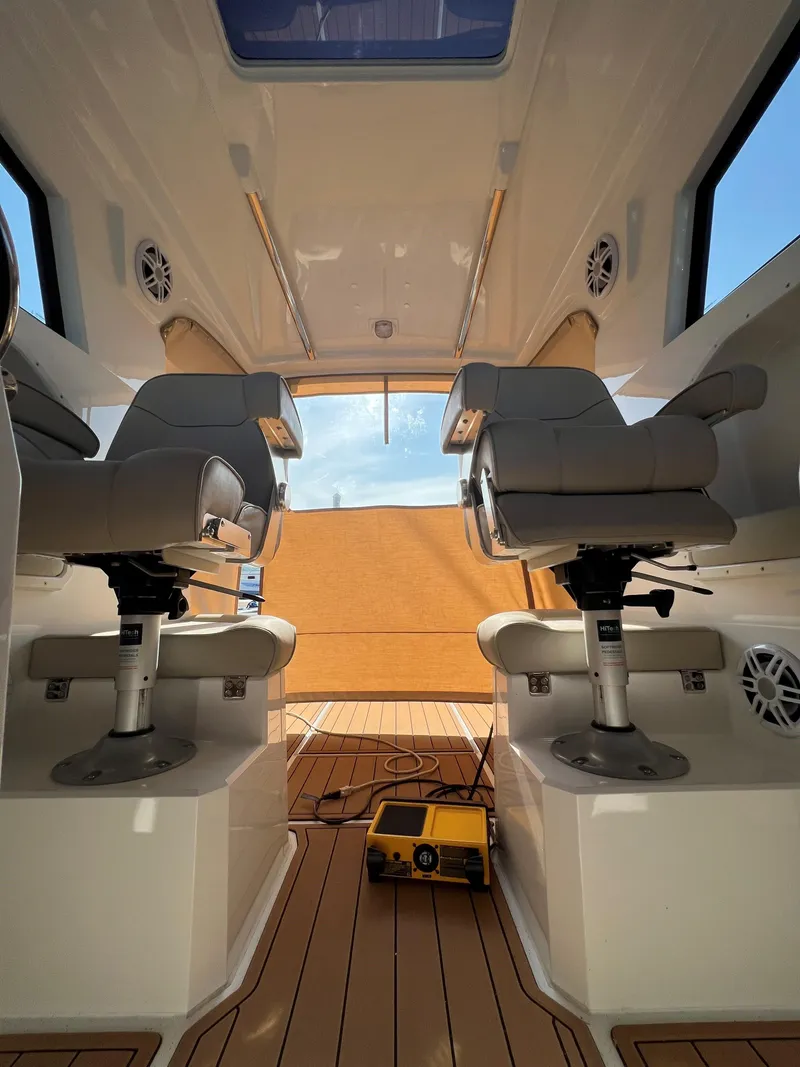 Slide: The Image of Interior of 2020 Protector 330 Targa boat with modern seating and wooden flooring. - 13
