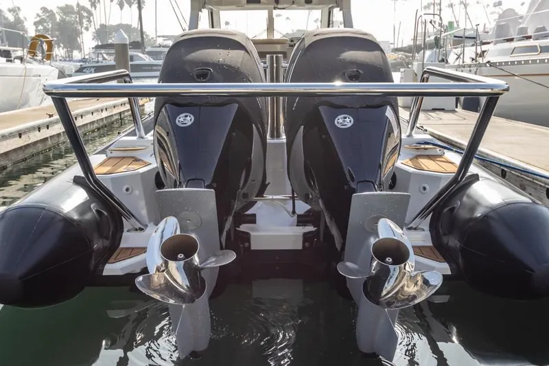 Slide: The Image of 2020 Protector 330 Targa boat with dual outboard engines docked at marina. - 18