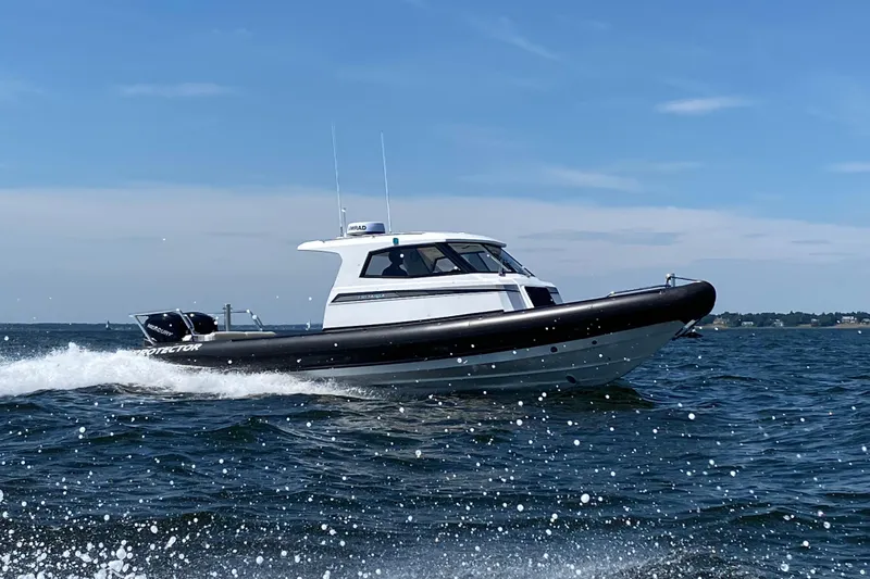 Slide: The Image of 2020 Protector 330 Targa boat cruising on open water. - 30