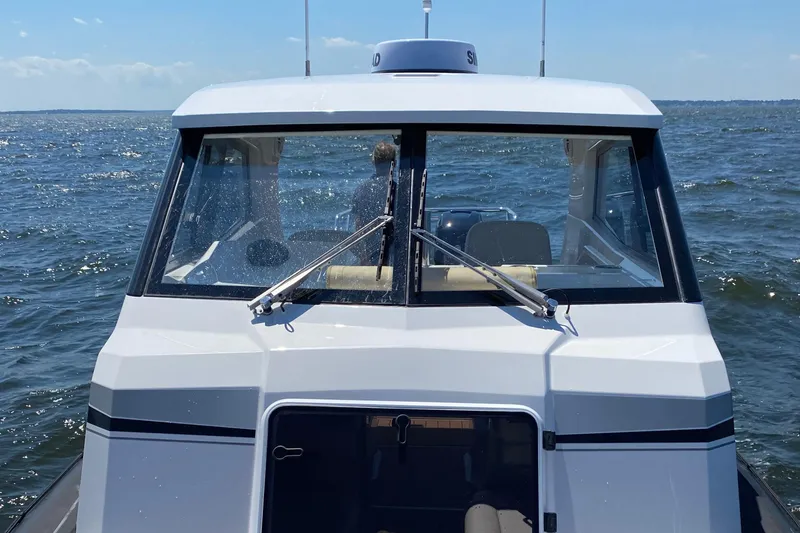 Slide: The Image of 2020 Protector 330 Targa boat on open water, front view. - 31