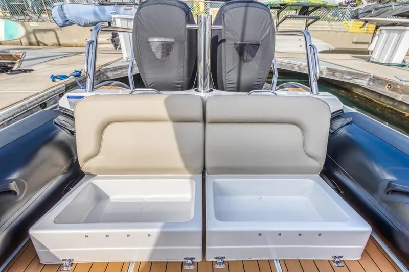Slide: The Image of 2020 Protector 330 Targa boat with open storage compartments on deck. - 33