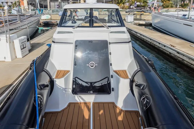 Slide: The Image of 2020 Protector 330 Targa boat docked at marina, featuring sleek design and wood accents. - 34