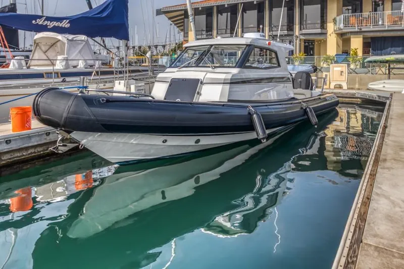 Slide: The Image of 2020 Protector 330 Targa boat docked in marina. - 35