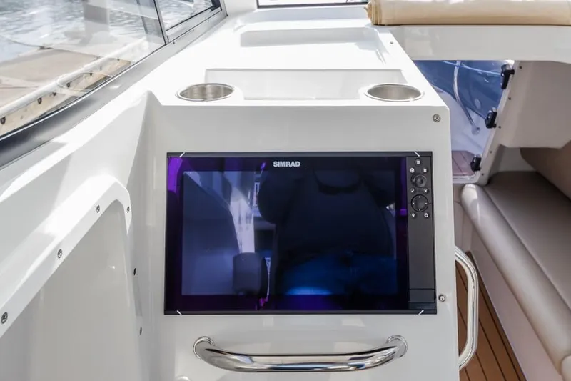 Slide: The Image of Protector 330 Targa 2020 boat interior with Simrad display and cup holders. - 37