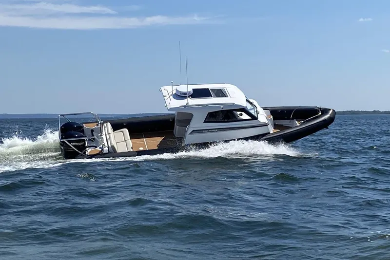 Slide: The Image of 2020 Protector 330 Targa boat cruising on open water. - 38