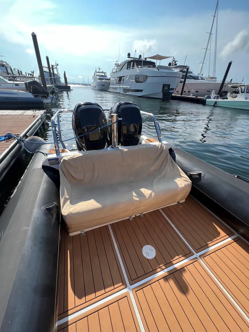 Slide: The Image of 2020 Protector 330 Targa boat docked in marina with twin engines. - 6
