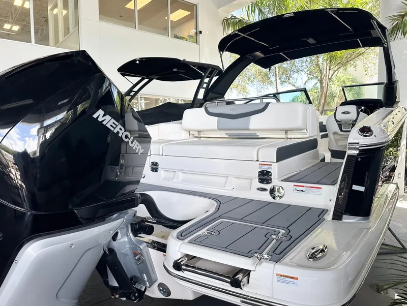 Slide: The Image of 2025 Chaparral 270 OSX OB boat with Mercury outboard engine, sleek design, and spacious seating. - 10