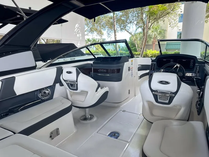 Slide: The Image of 2025 Chaparral 270 OSX OB boat interior with modern seating and sleek design. - 13