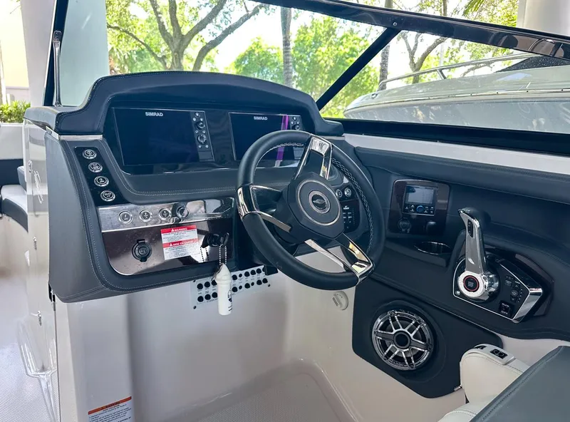 Slide: The Image of 2025 Chaparral 270 OSX OB boat cockpit with modern steering and control panel. - 18
