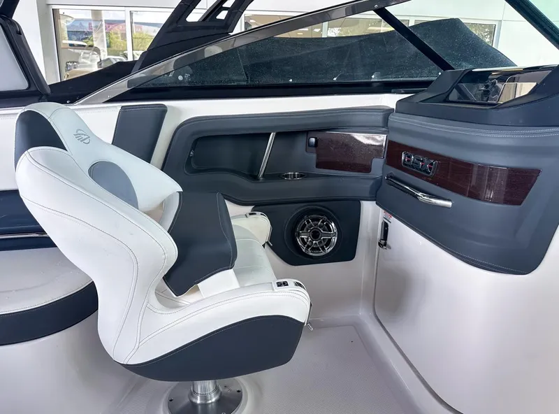 Slide: The Image of Interior of 2025 Chaparral 270 OSX OB boat with modern seating and dashboard. - 19
