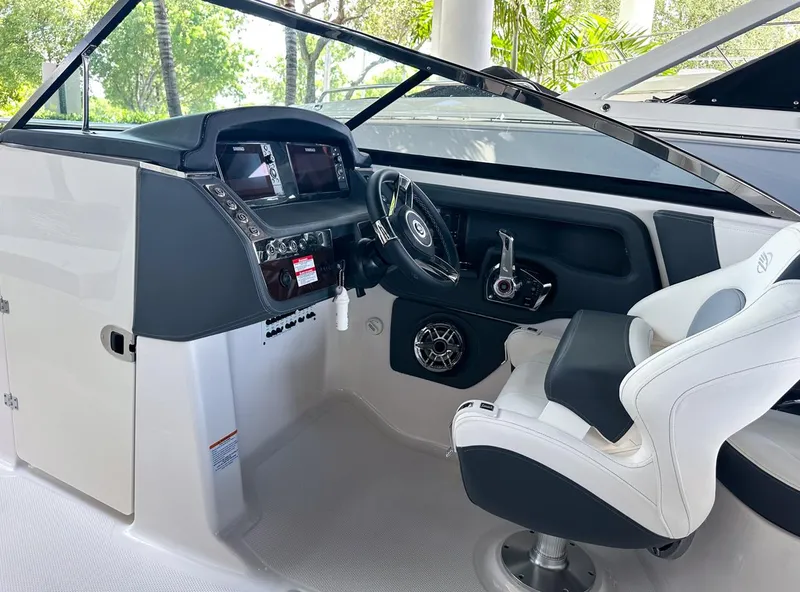Slide: The Image of 2025 Chaparral 270 OSX OB boat cockpit with modern steering and controls. - 22