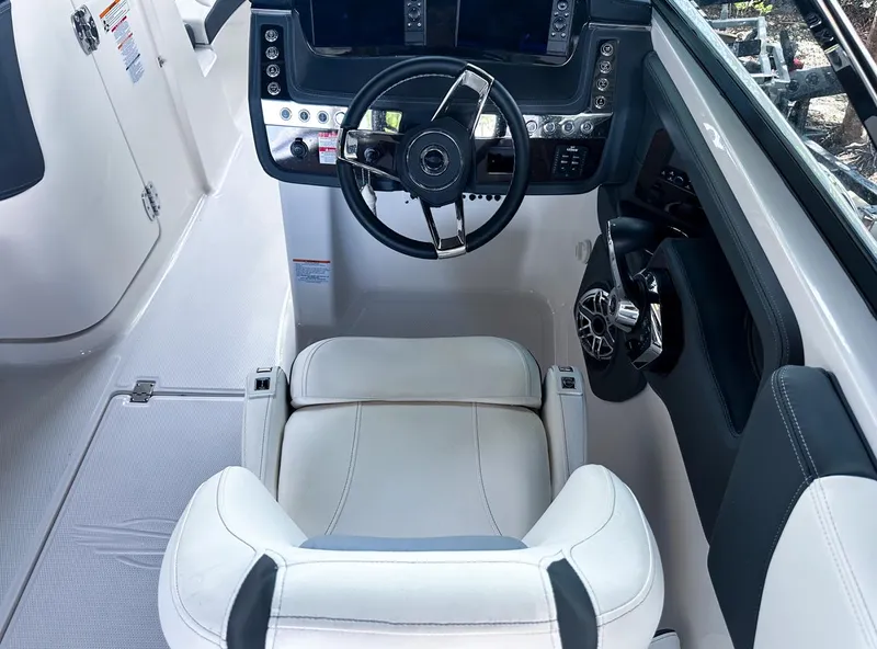 Slide: The Image of 2025 Chaparral 270 OSX OB boat cockpit with modern steering and controls. - 24