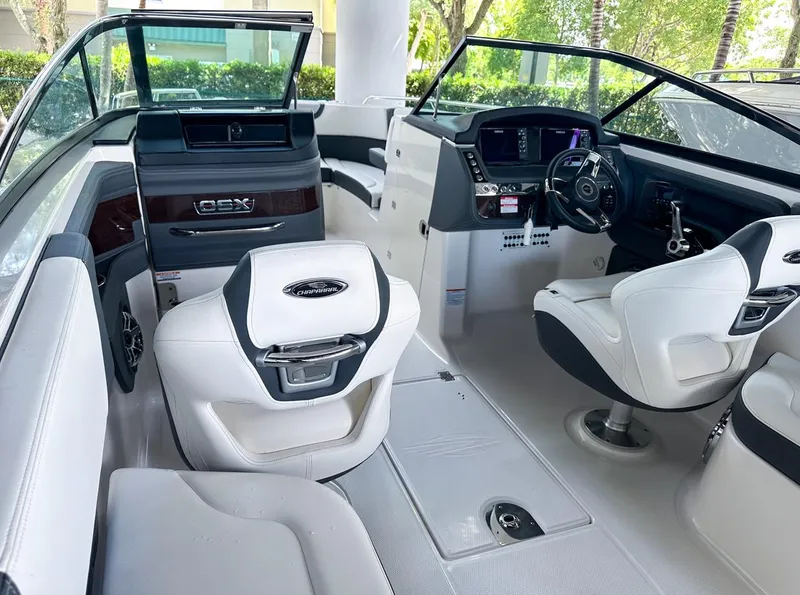Slide: The Image of Interior of 2025 Chaparral 270 OSX OB boat with modern seating and dashboard. - 25