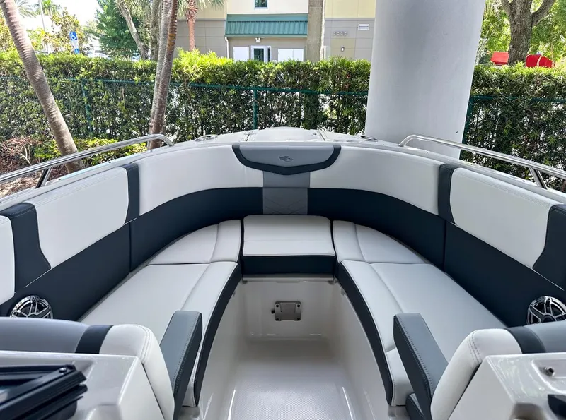 Slide: The Image of 2025 Chaparral 270 OSX OB boat interior with cushioned seating and sleek design. - 26