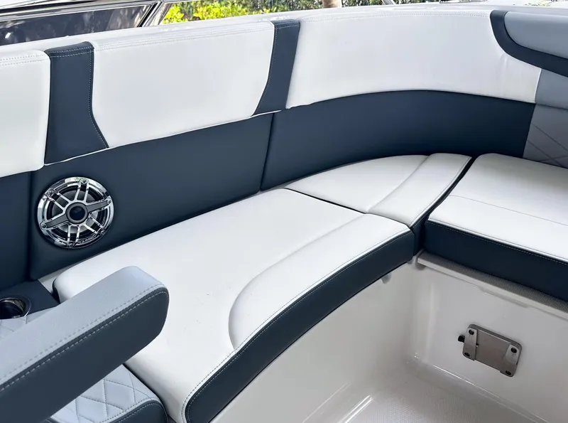 Slide: The Image of 2025 Chaparral 270 OSX OB boat interior with cushioned seating and speaker. - 27