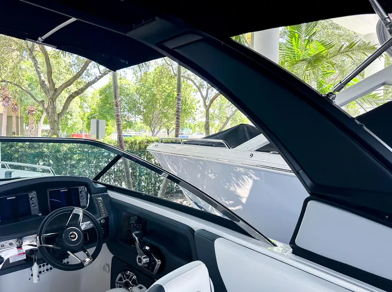 Slide: The Image of 2025 Chaparral 270 OSX OB boat interior with steering wheel and dashboard. - 32