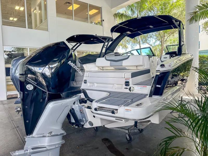 Slide: The Image of 2025 Chaparral 270 OSX OB boat with Mercury outboard engine in showroom setting. - 4